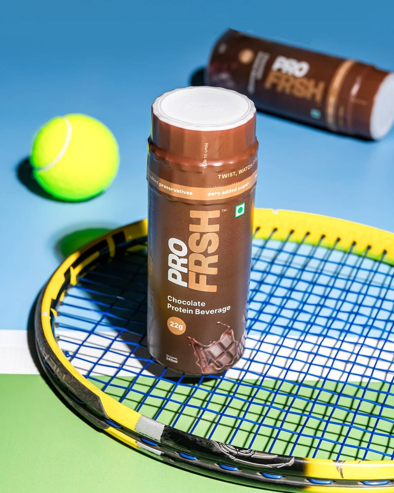 Pro Frsh bottle on a tennis racket courtside, shake it up