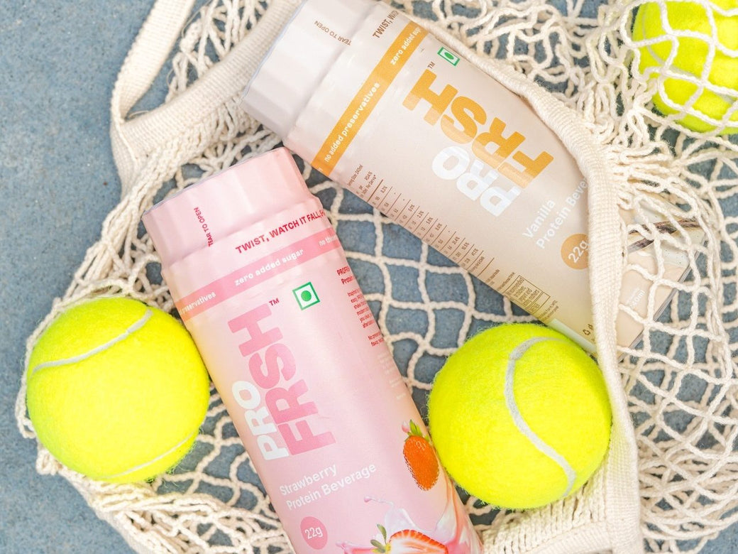 Pro Frsh strawberry and vanilla bottles in a woven net bag with tennis balls